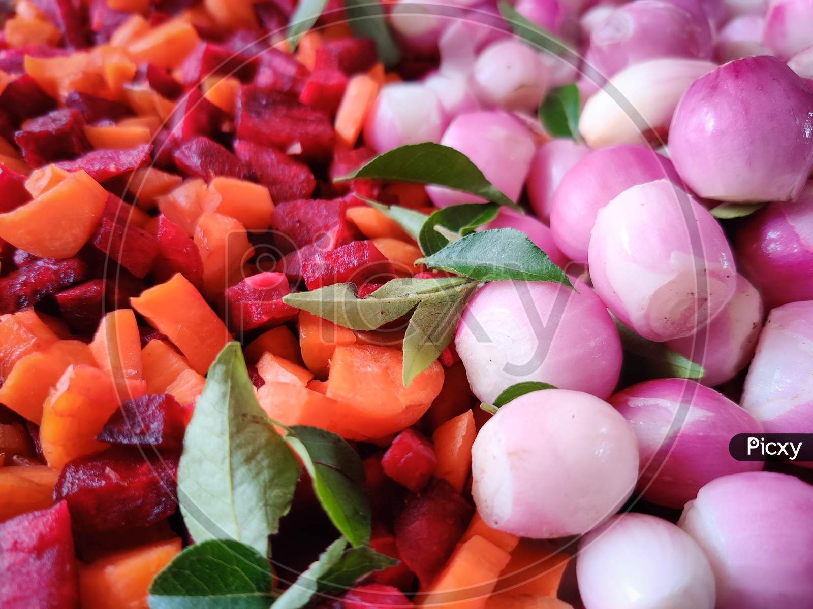 Closeup Of Uncooked Carrots,Beetroots,Small Onions,Curry Leaves. Vegetables
