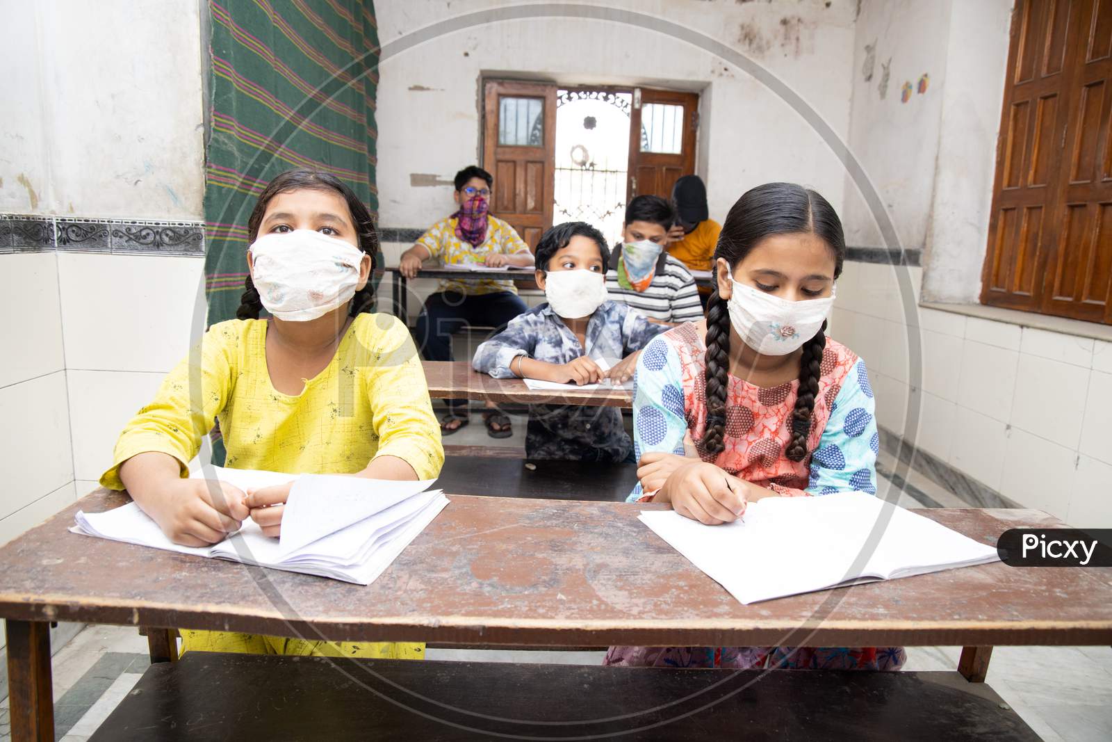 Indian Students Studying In Classroom Wearing Mask And Social Distancing, School Reopen During Covid19 Pandemic