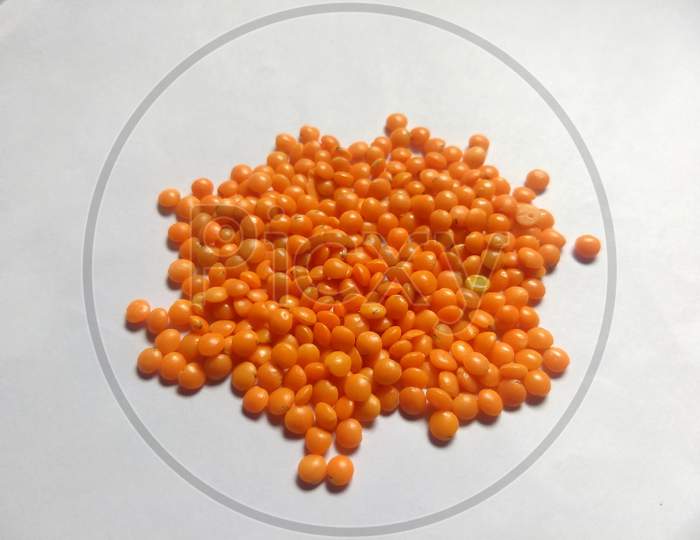 Red lentils in white background
