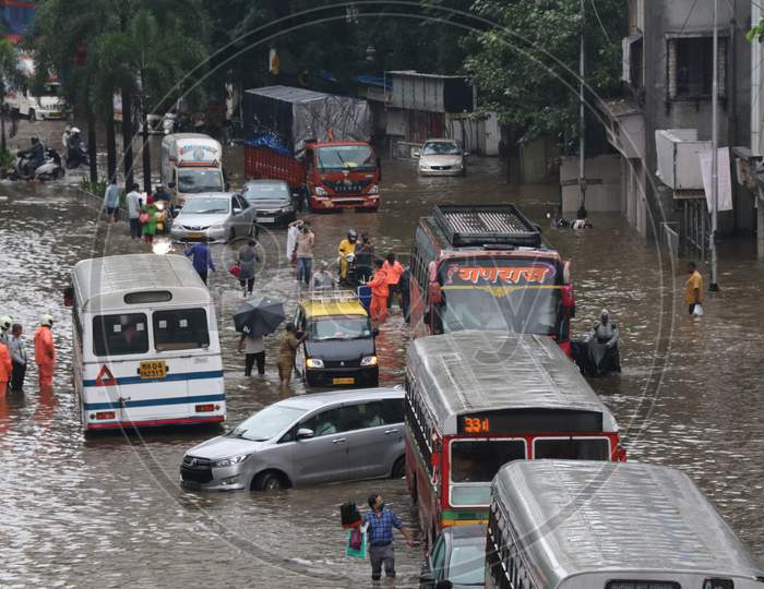 Vehicles pass through waterlogged road after heavy rainfall in Mumbai, India, September 23, 2020.