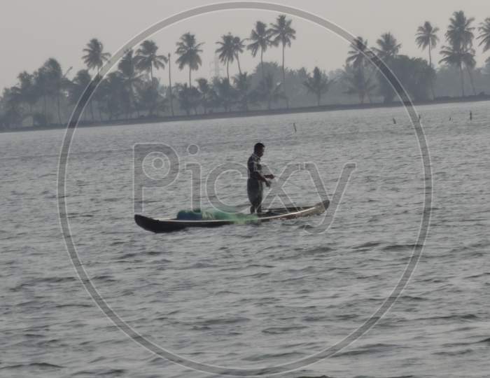 fisherman fishingin the backwatersof kerala