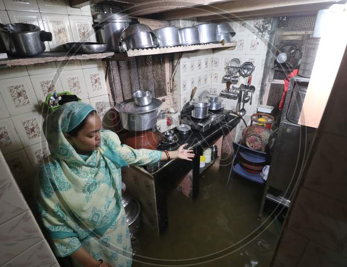 A woman show the kitchen inside her house that is waterlogged due heavy rains, in Mumbai, India on September 23, 2020.