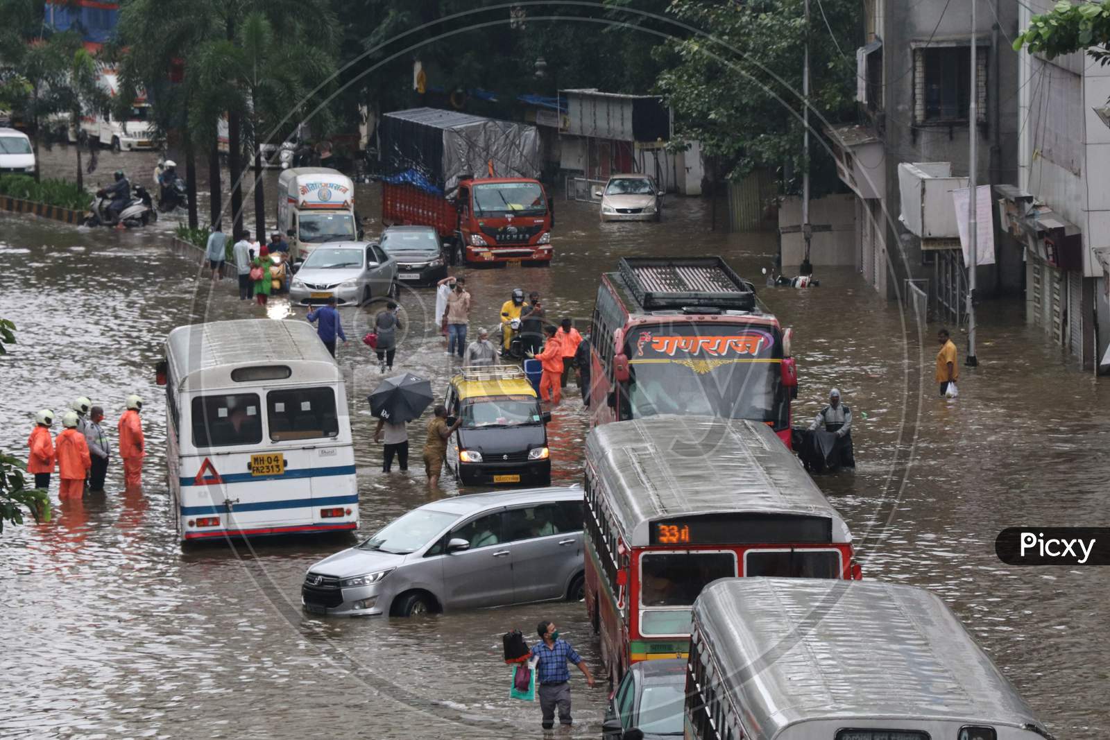 Vehicles pass through waterlogged road after heavy rainfall in Mumbai, India, September 23, 2020.