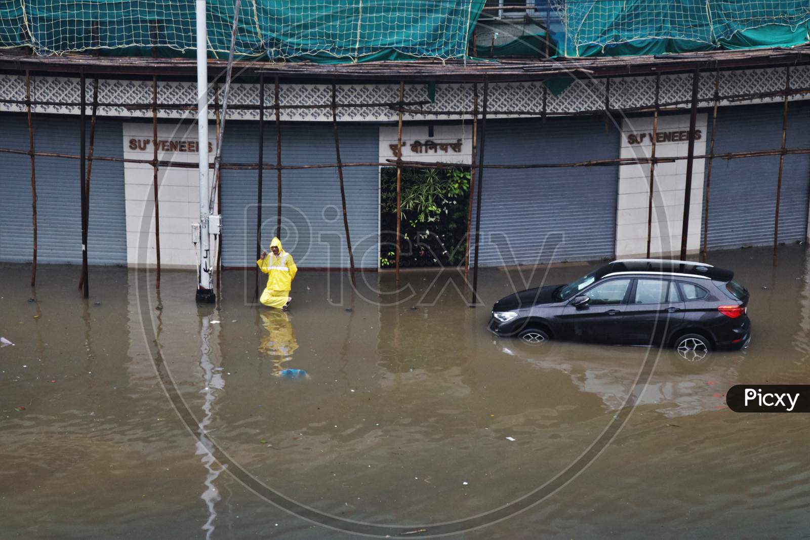 A policeman stands on a waterlogged road after heavy rainfall in Mumbai, India, September 23, 2020.