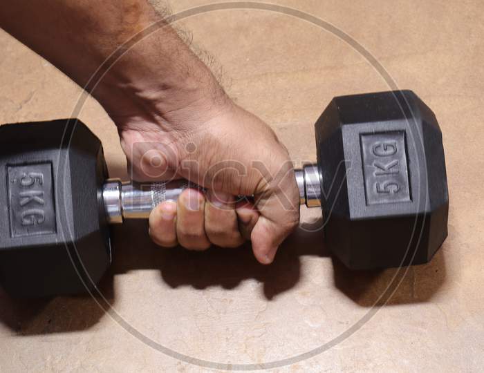 Black colour Gym Dumble for Fitness on Wood background