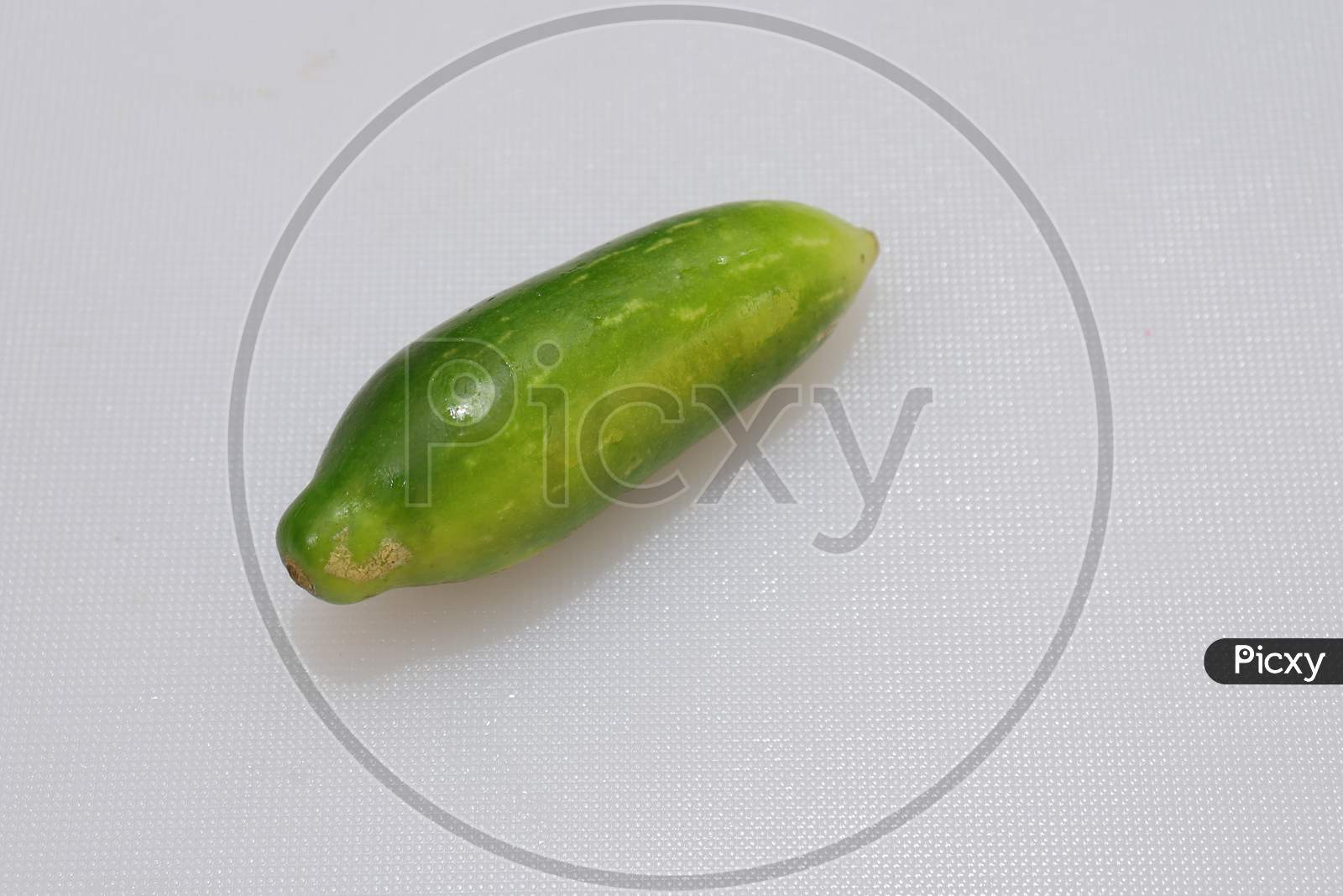 Organic Raw green Coccinia grandis or Ivy gourd on a white background