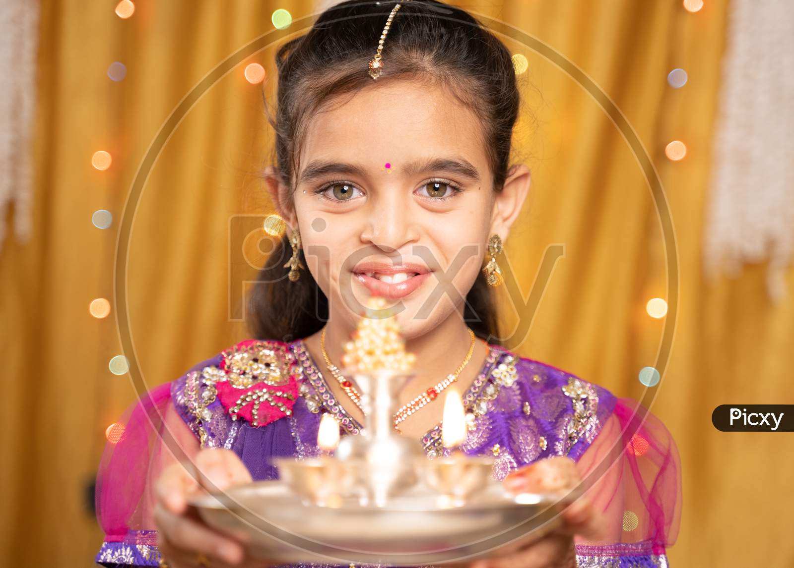 Pov Shot Of Cute Little Girl In Traditional Dress Doing Aarti Or Offering Light To God During Hindu Religious Festival Ceremony.