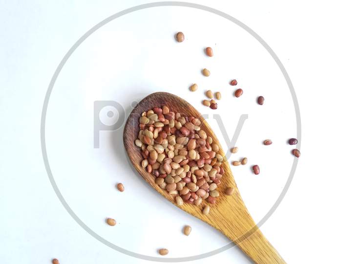 Horse gram in wooden spoon isolated in white background