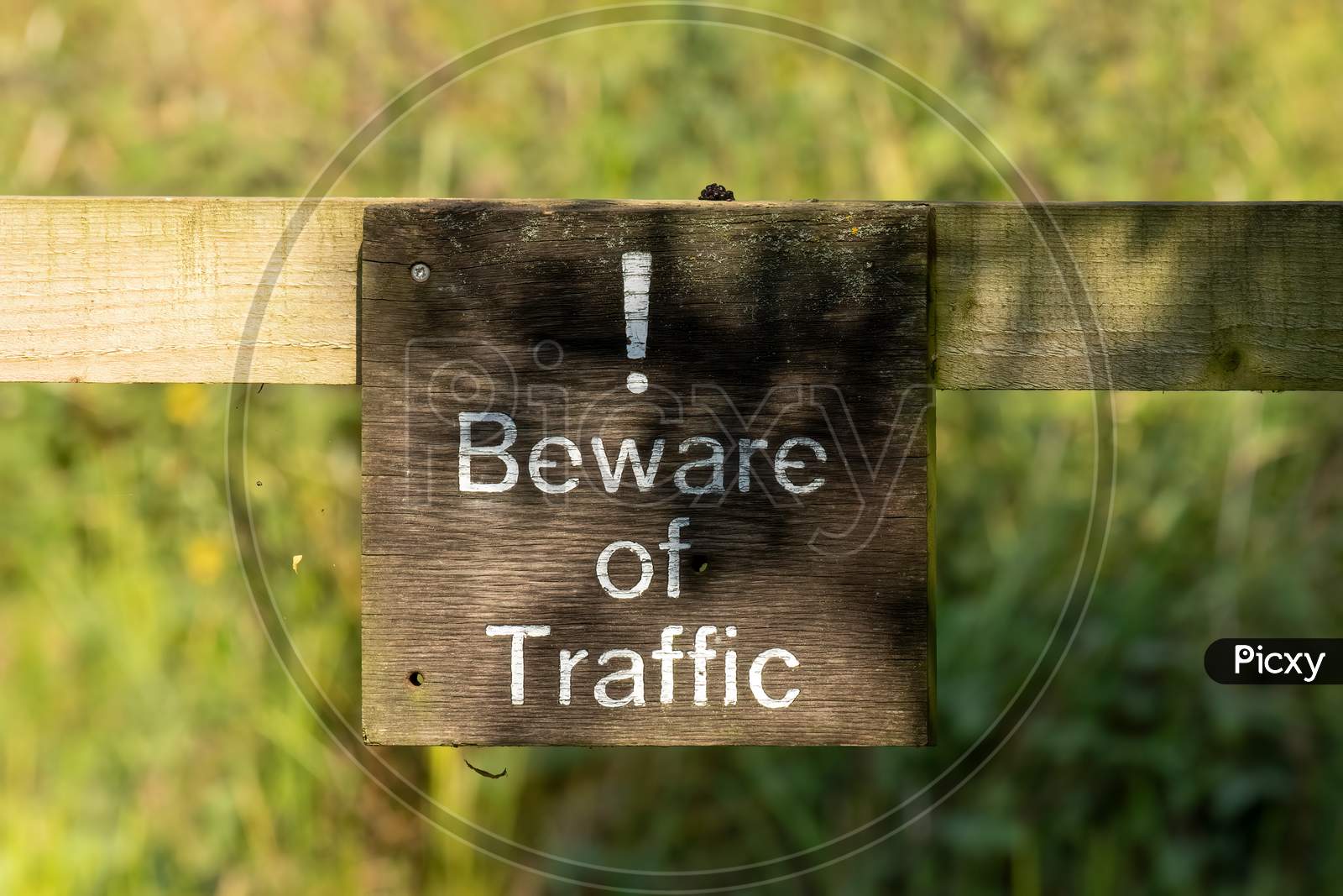 Wooden Sign Advising To Beware Of Traffic Ahead