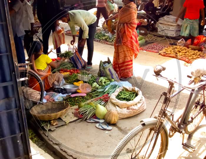 A woman selling vegetable in Indian market,vegetable market,economy