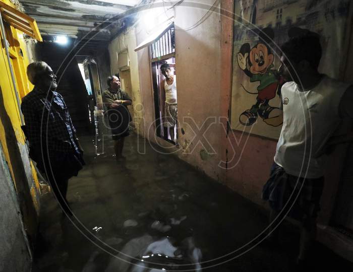 People stand outside their houses that are waterlogged due heavy rains, in Mumbai, India on September 23, 2020.