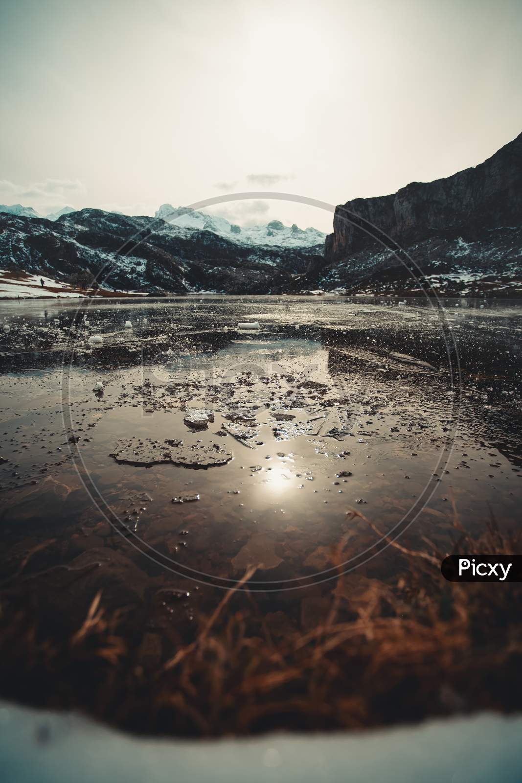 Frozen Water And Pieces Of Ice In A Frozen Lake In The Middle Of The Mountains During Winter