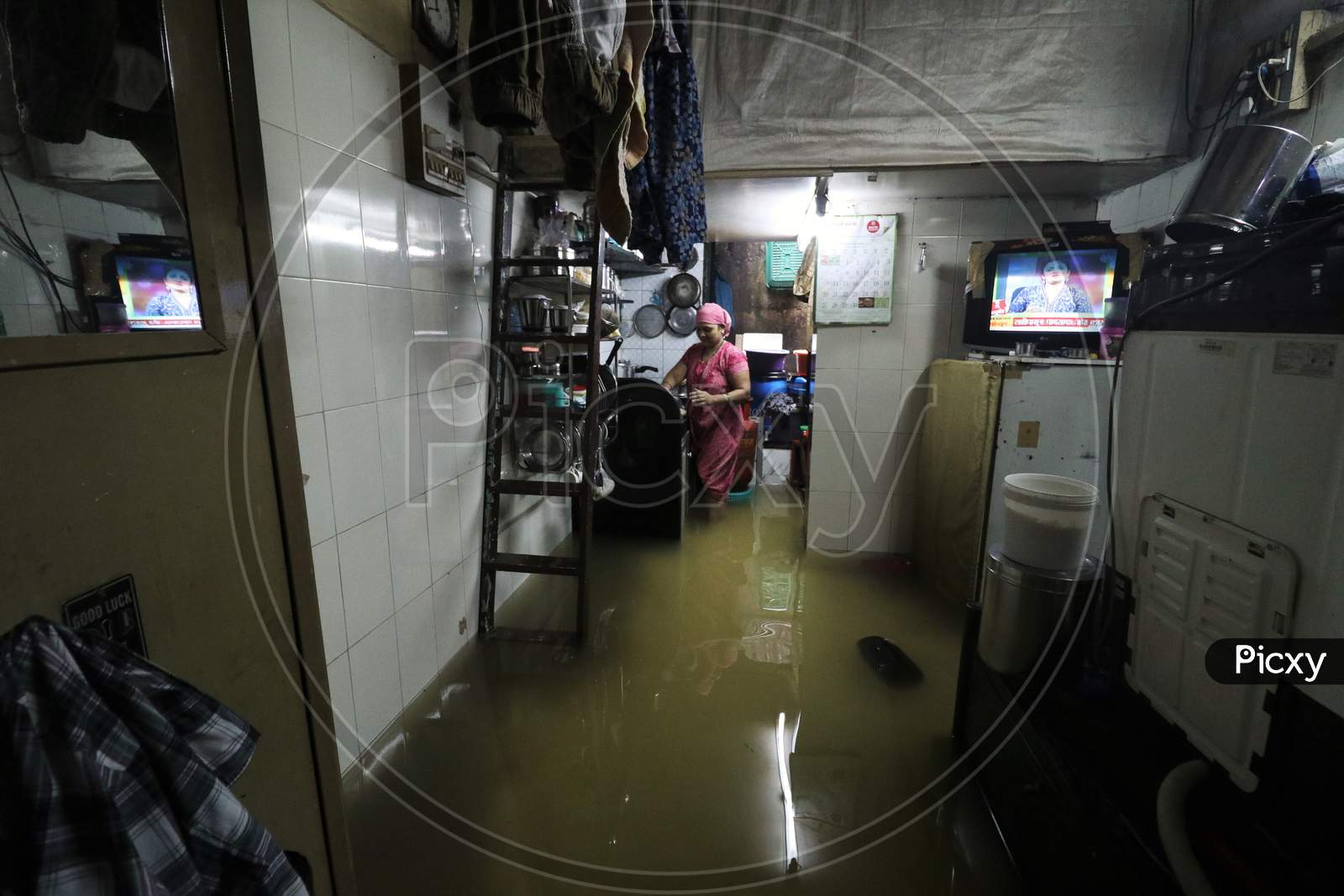 A woman is seen inside her house that is waterlogged due heavy rains, in Mumbai, India on September 23, 2020.