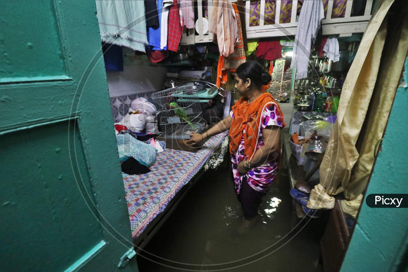 A woman is seen inside her house that is waterlogged due heavy rains, in Mumbai, India on September 23, 2020.