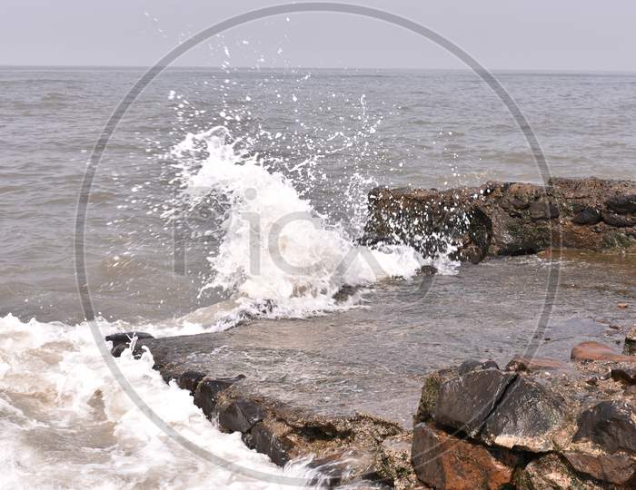 Water Waves Hitting The Rocks Near Mumbai Shore