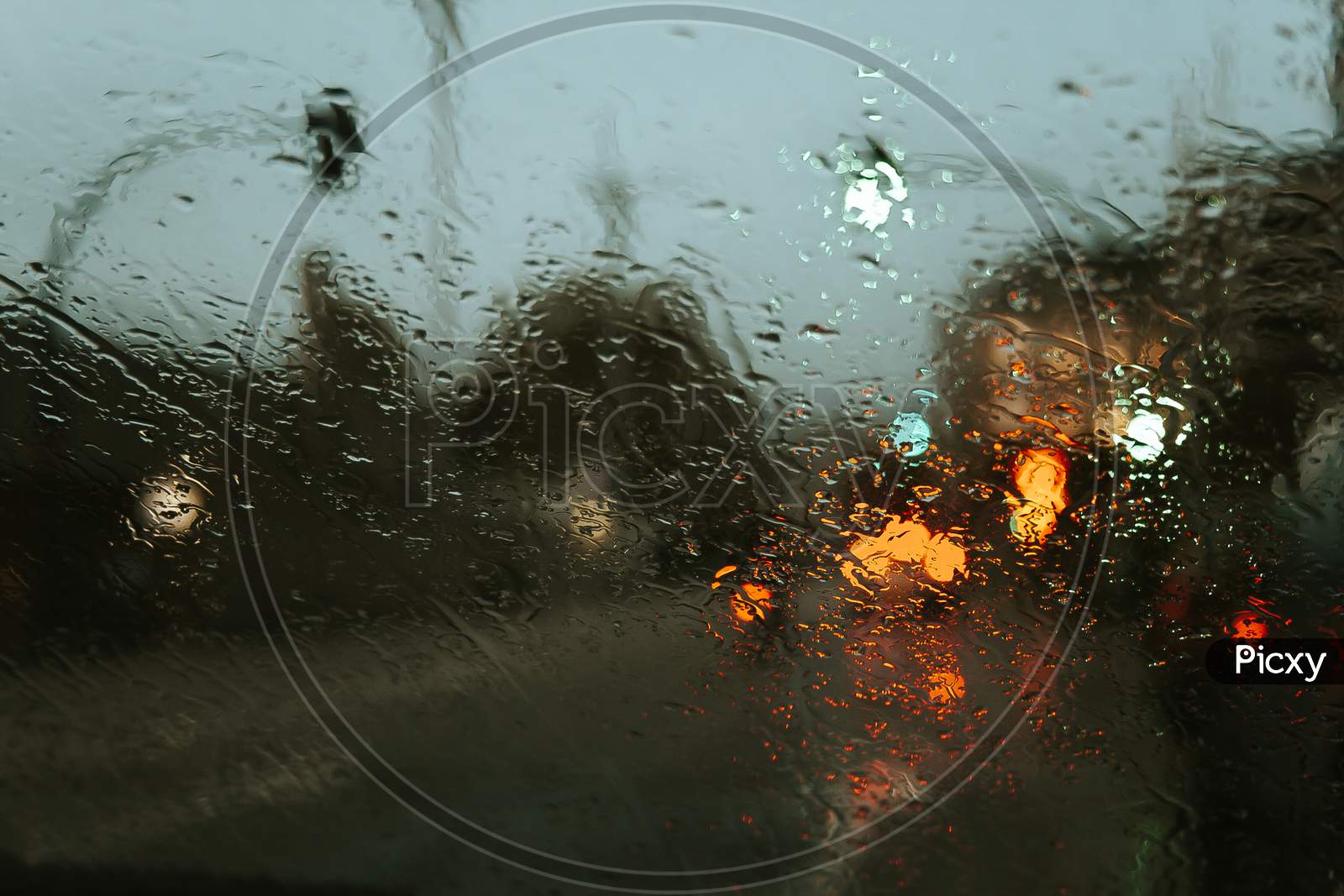 Rain Drops Over The Crystal Of The Car With A Super Texture And Colorful Reflections
