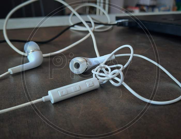 White Wired Earphones Tangled Up Selective Focus