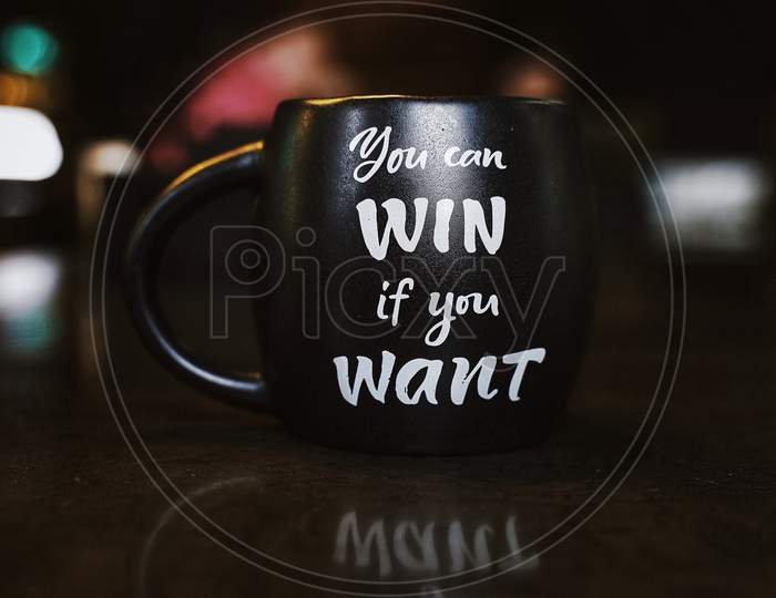 Close-Up Photo of Black Ceramic Mug with Inspirational Motivational Quote " you can WIN if you Want ".
