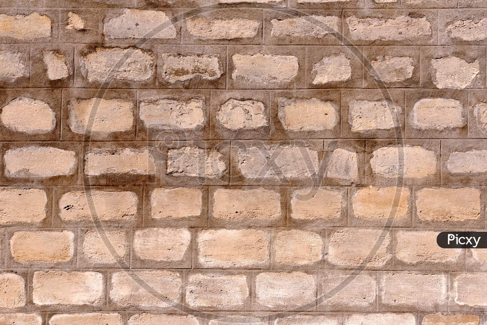 A Brown Cemented Wall Made Up Of Visible Bricks Attached With Wet Cement