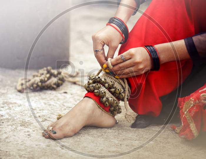 dance form indian classical feet with ghungru.Kathak Girl tying ghungaroo.