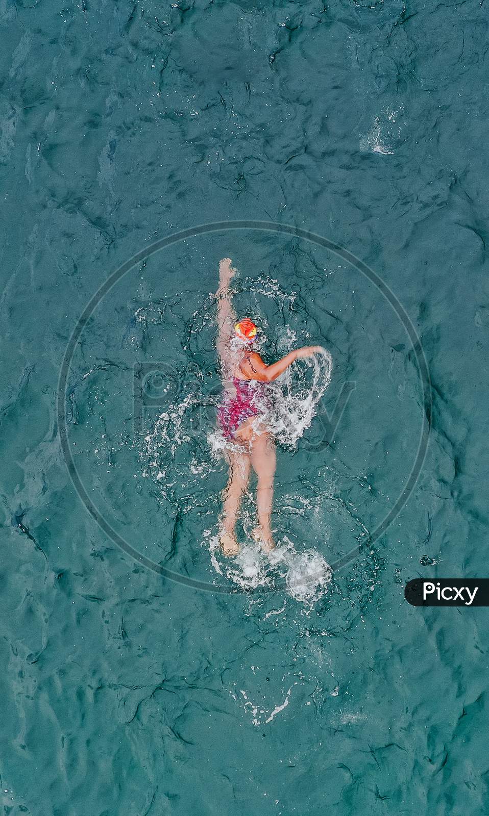 Women swimming professionally in seawater.