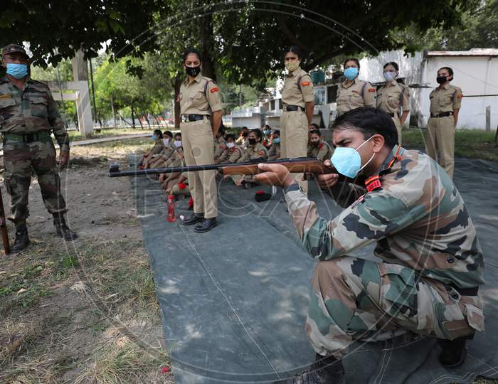 Army officer along with NCC cadets busy in firing practice at a camp in Jammu on26 September.2020.