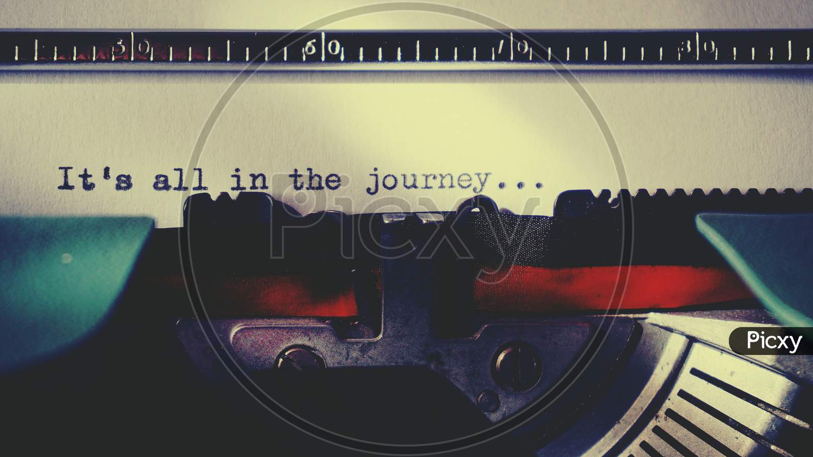 Black Typewriter Machine Typing Life's Quote "It's all in the Journey " on White Printer Paper.