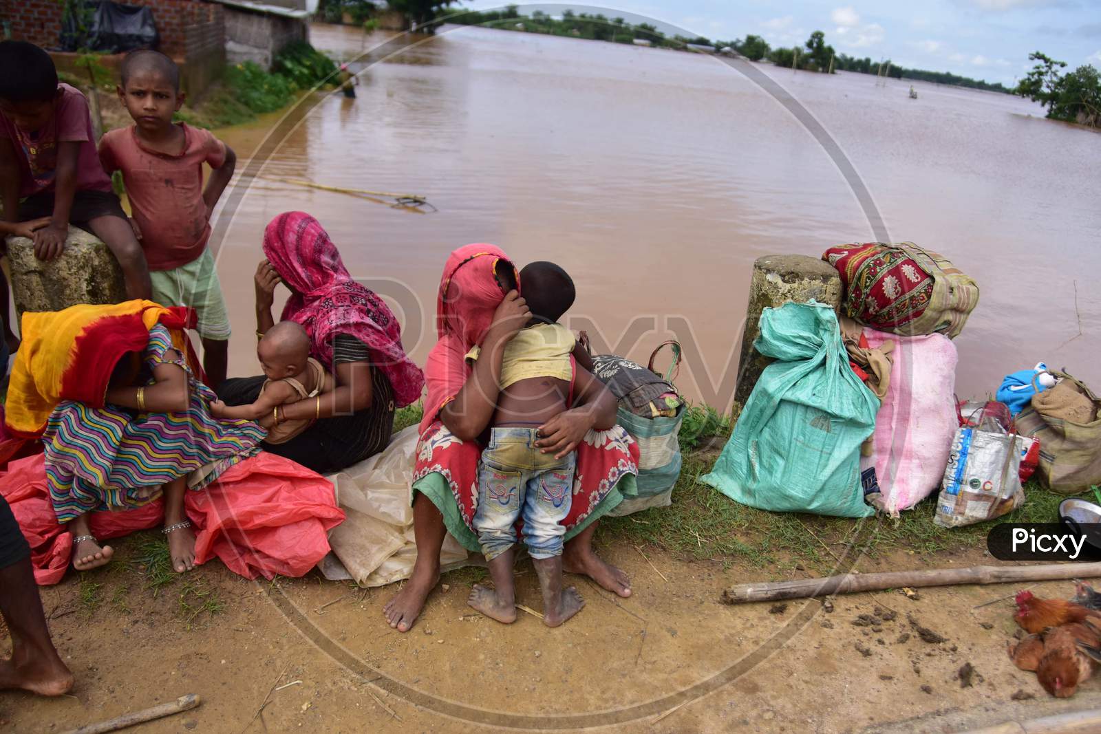 Flood-affected villagers take shelter on a road  at Raja Ali village  near Kampur in Nagaon in the northeastern state of Assam on Sept 26,2020.