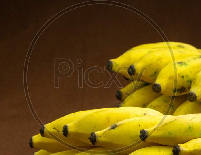 Two Bunches Of Banana Fruit On A Matte Background