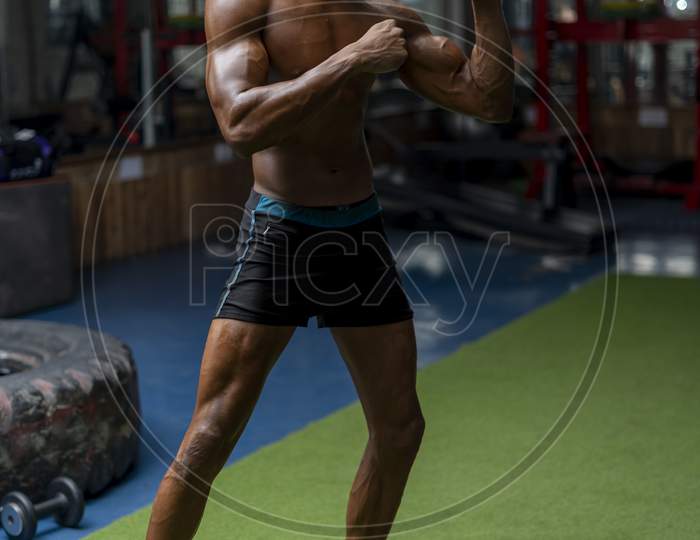 Young Shredded And Fit Boy Working Out In The Gym,Standing In A Boxing Pose.