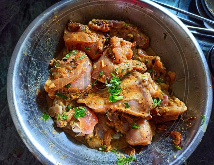Marinated chicken meat with indian masala in a bowl.