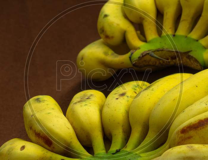 Two Bunches Of Banana Fruit On A Matte Background