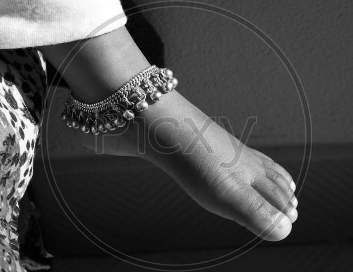 Closeup Shot Of Indian Girl Child Ankle Bracelet Isolated On Bare Feet