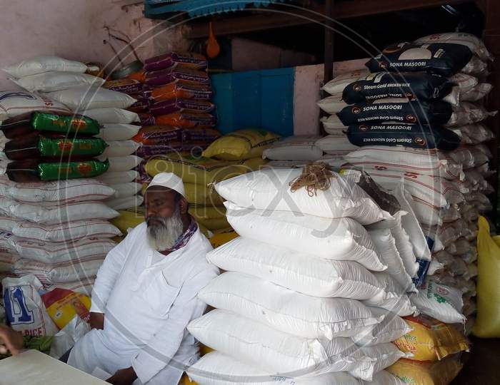 a muslim shopkeeper sat in grains shop