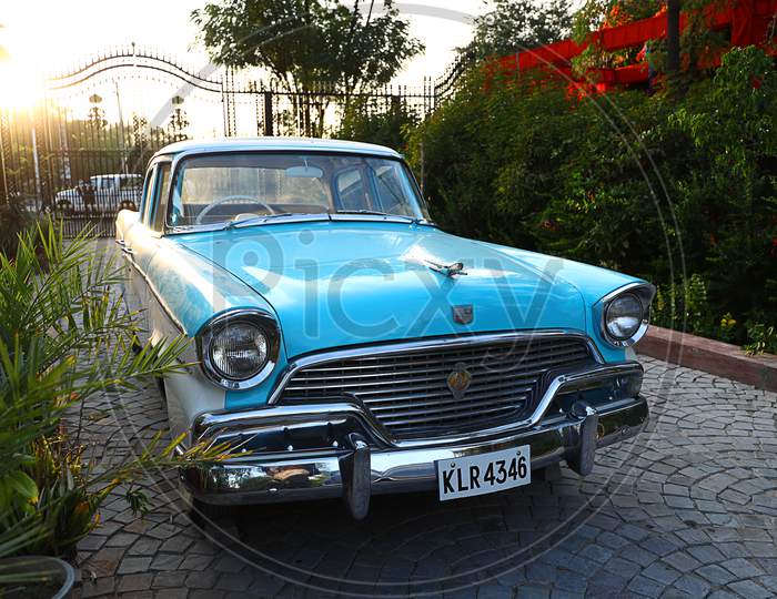 Portrait Of An Old Retro Blue Commander Vintage Car Parked At Driveway Of A House, Outdoor Bright Sun Natural Background, Vintage Car Collectors In India