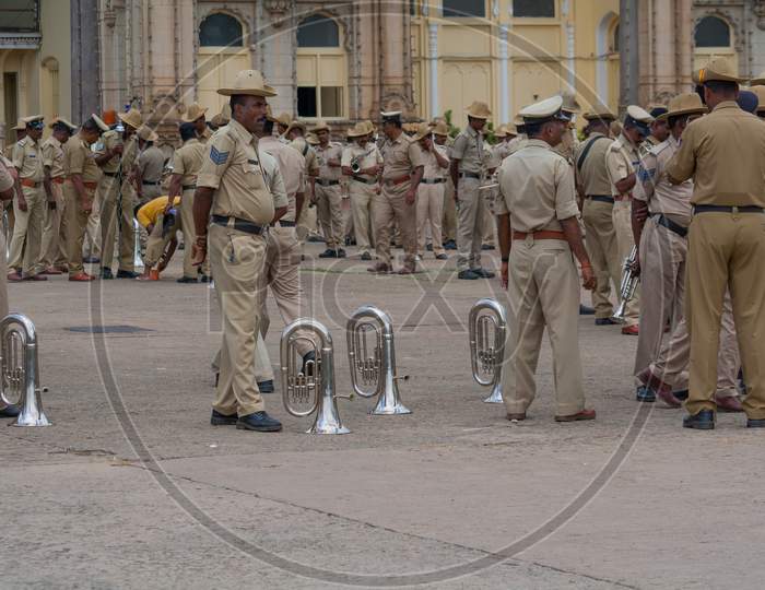 A Graceful picture of the Police Band team with their Instruments seen relaxing during the rehearsel of Instrumental Music sessions for the Dasara Festival at Mysuru Royal Palace in Karnataka/India.