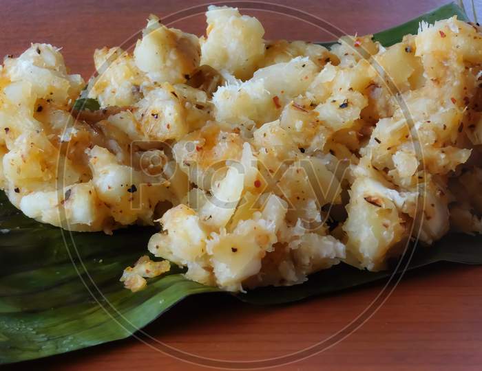Closeup Of A Dish (Tapioca Curry) In A Banana Leaf Isolated On A Wooden Surface