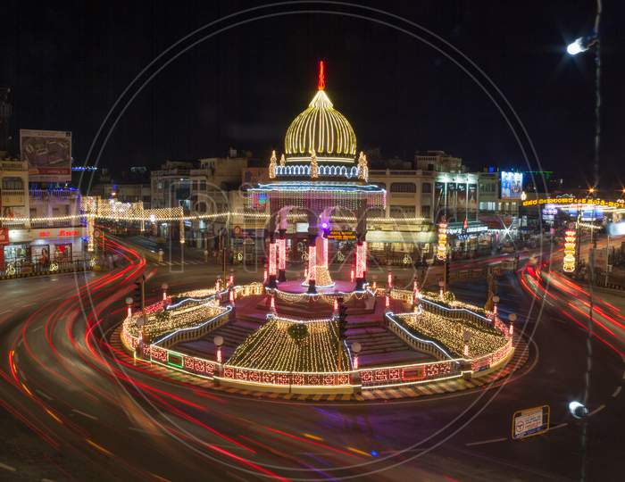 A Dramatic Evening view of the Illuminated Maharajah Circle with Red Light Trails from the Traffic in the Heart of Mysuru city during Dasara Festival in Karnataka/India.