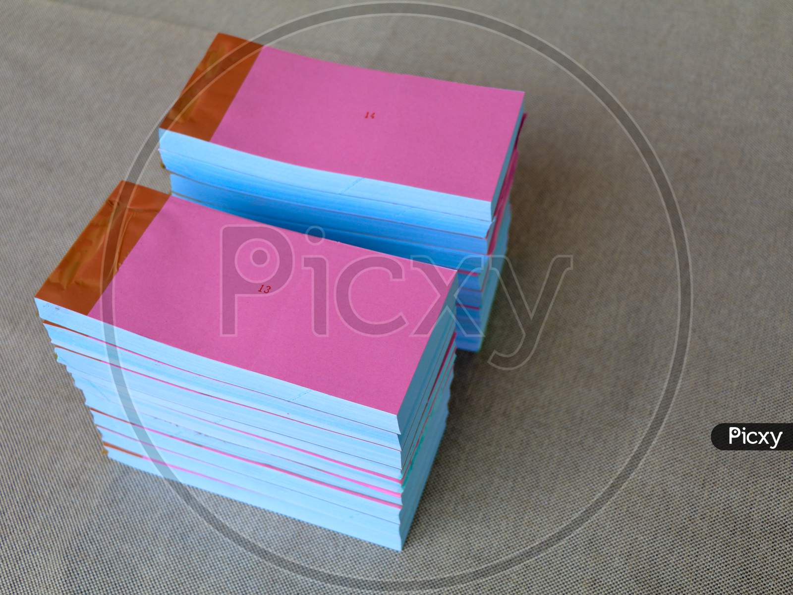 Light Rose Color Bill Books Or Receipt Books On A Cream Color Furnishing Cloth
