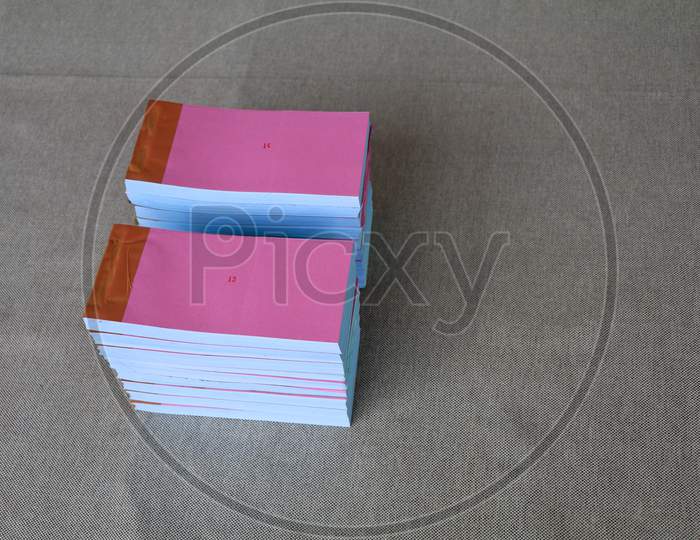 Light Rose Color Bill Books Or Receipt Books On A Cream Color Furnishing Cloth