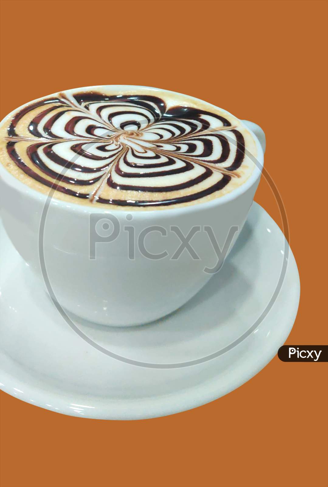 A Cup Of Coffee With Latte Art On Top Of It With Brown Background.