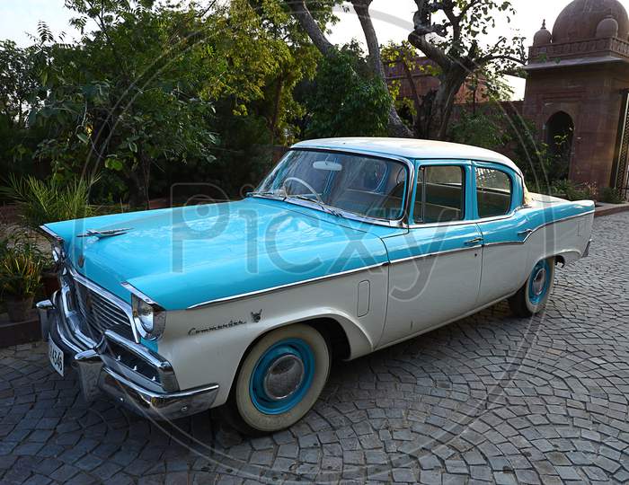 Portrait Of An Old Retro Blue Commander Vintage Car Parked At Driveway Of A House, Outdoor Natural Background, Vintage Car Collectors In India