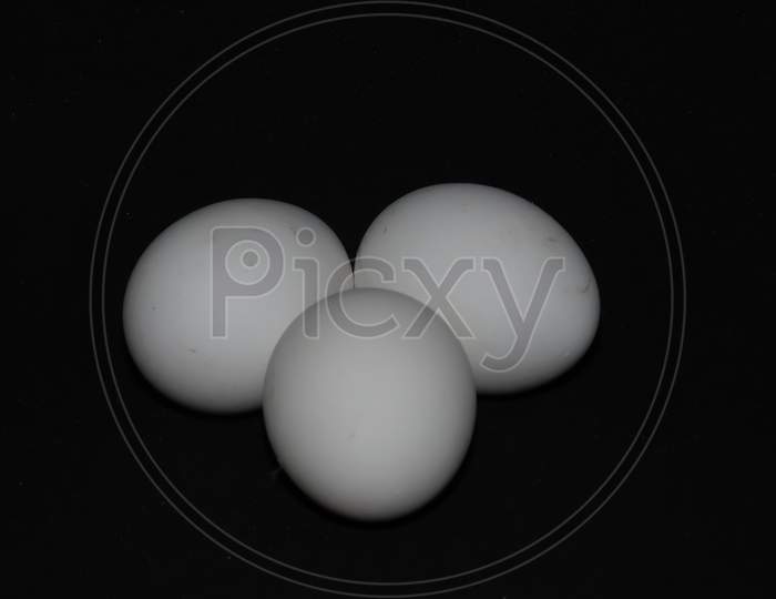 Closeup Of White Eggs Isolated On Black Background