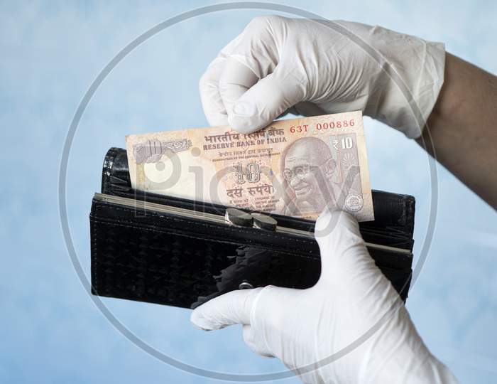 Woman Taking Money Out Female Wallet Wearing Rubber Gloves To Prevent The Spread Of Bacterias Or Viruses, Take Shopping During Coronavirus Pandemic. Microbes On Money. Refusal Of Cash.