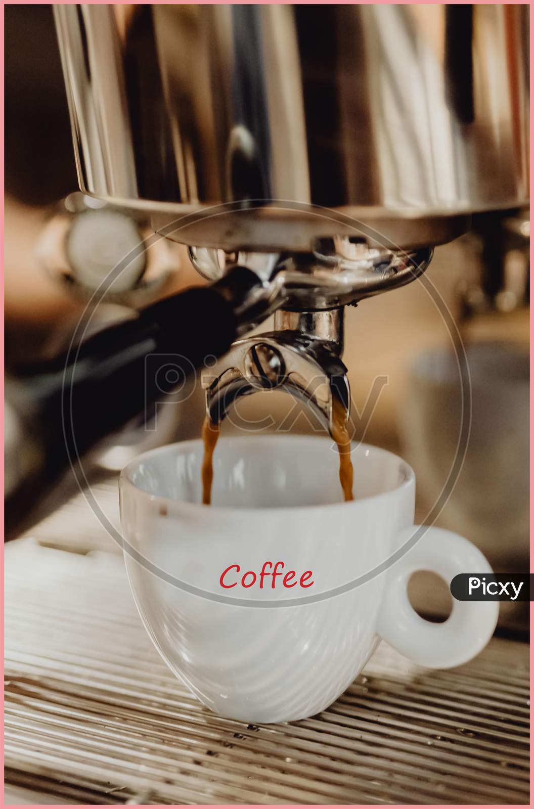 Close-up of coffee pouring from coffee machine into white cup at  restaurant