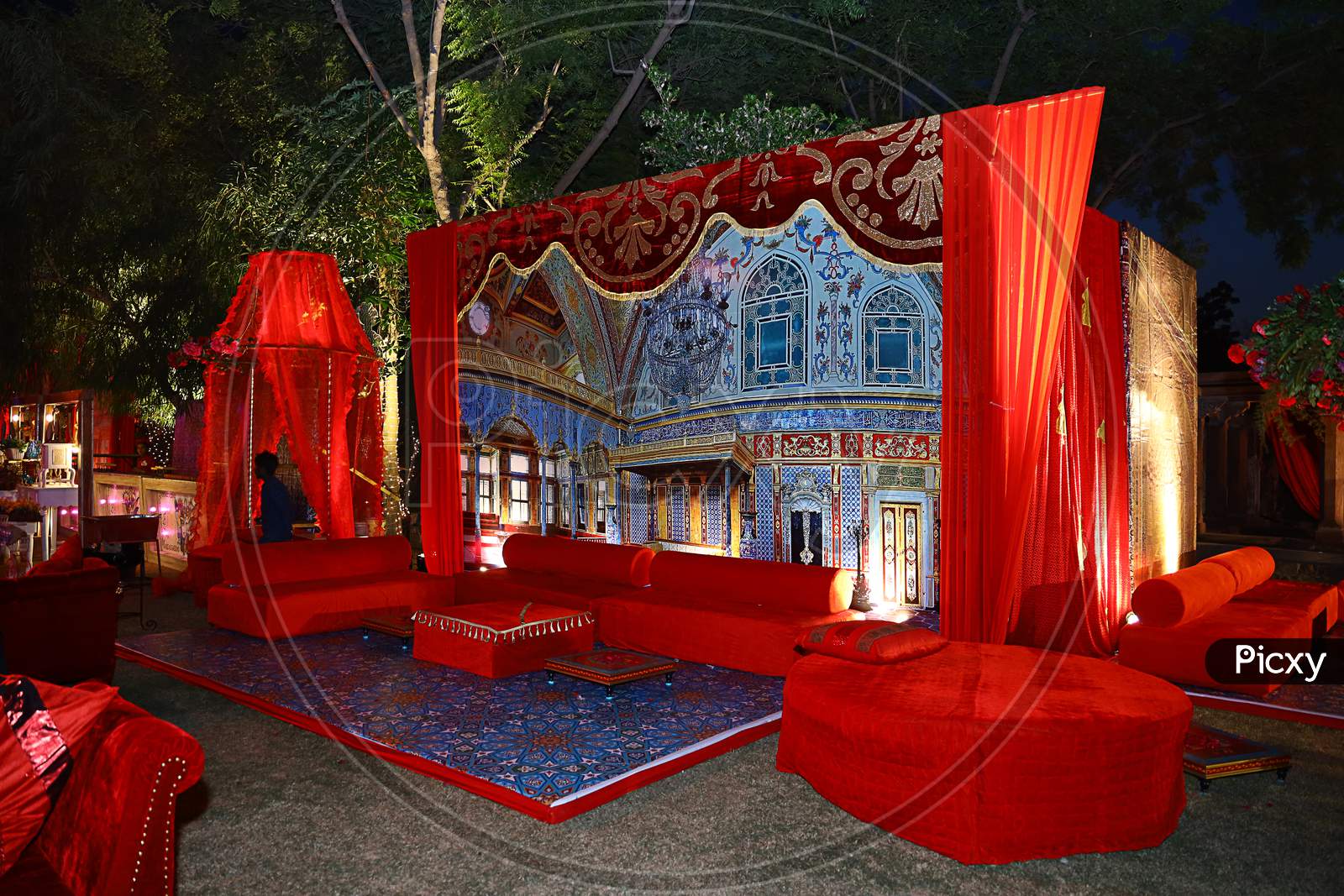 Beautifully Decorated Red Sofas Or Couch Ready For The Guests Sitting At A Wedding Ceremony In Backyard, Night Ceremony Venue, Wedding Event Decor Concept