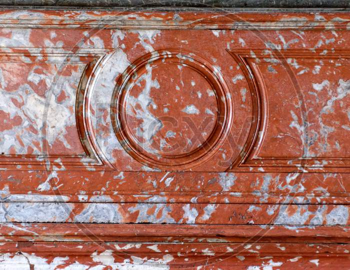 A Ruined Marble Wall With Some Red Paint Splash Over It With Unique Concentric Circle Pattern Made Up Of Marble