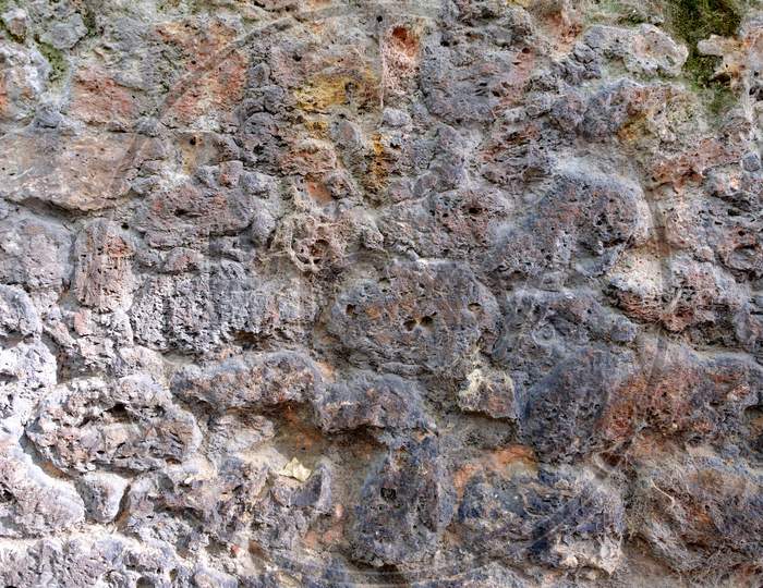 A Wall Near Waterfall Formed By Sedimentary Rocks