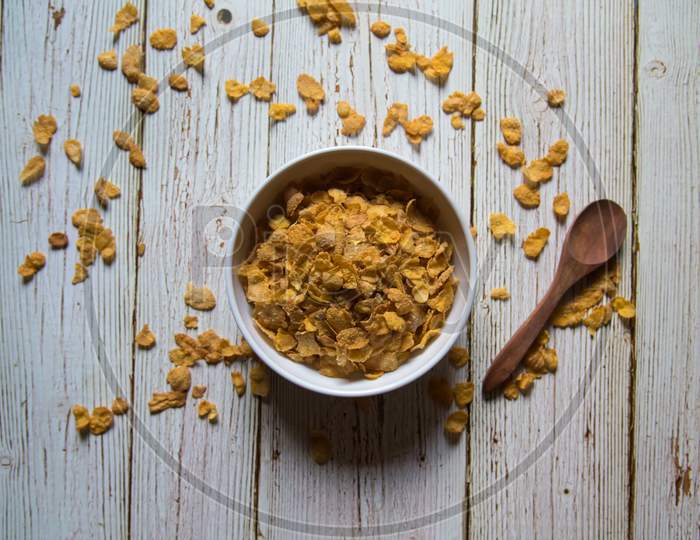 View from above of corn flakes in a bowl on a background