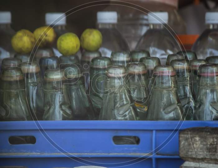 Empty Bottles And Lemons Kept On A Tray In A Shop
